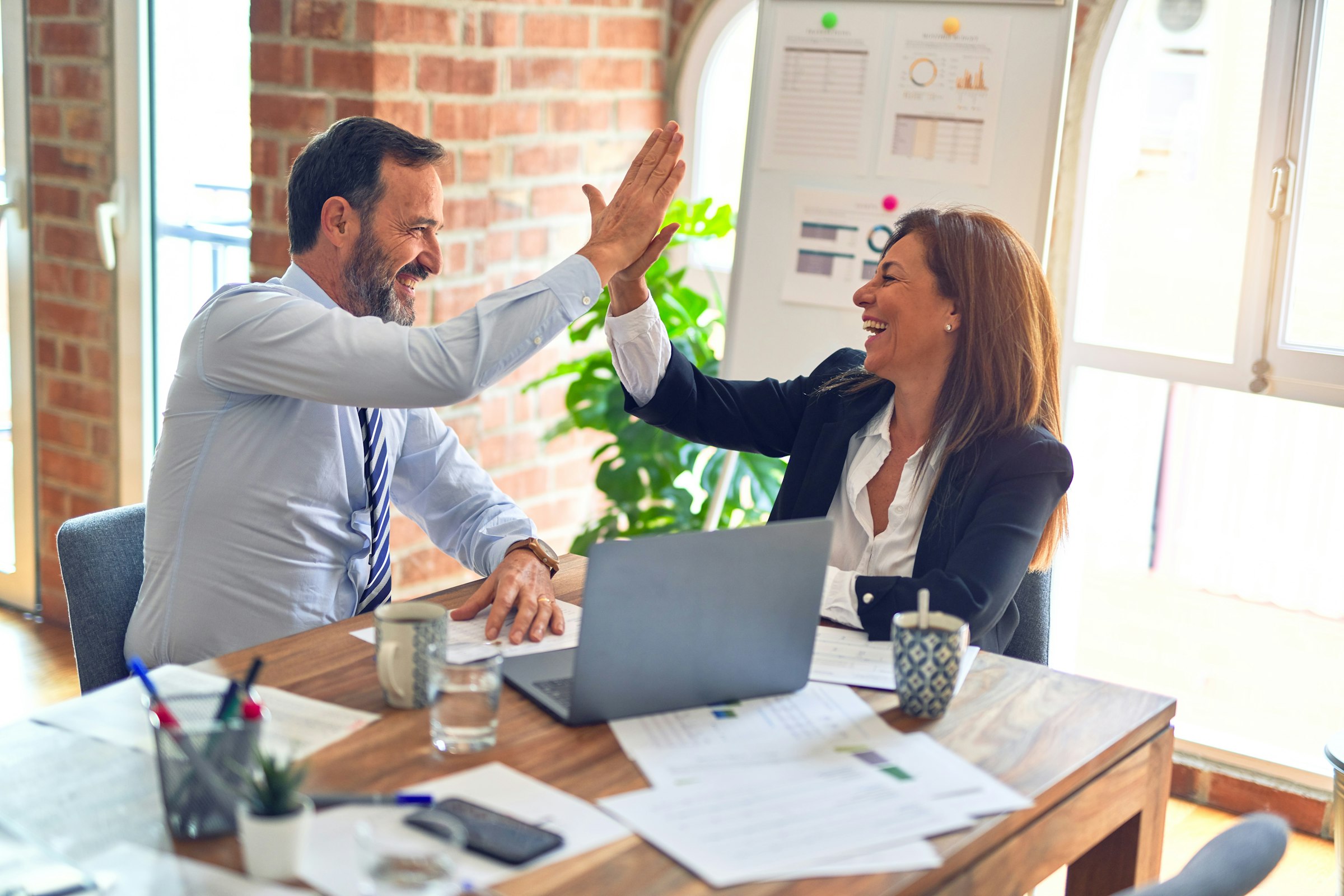 Two colleagues reviewing work together in an office